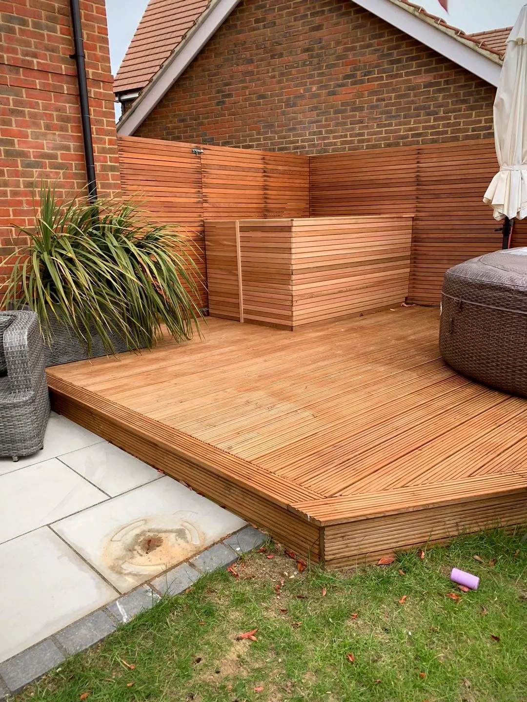 Cedar deck and garden bar in West Sussex garden