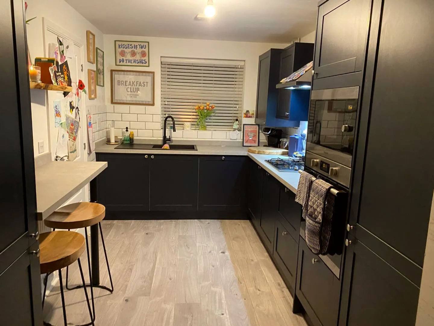 Navy shaker kitchen with island and pendant lights