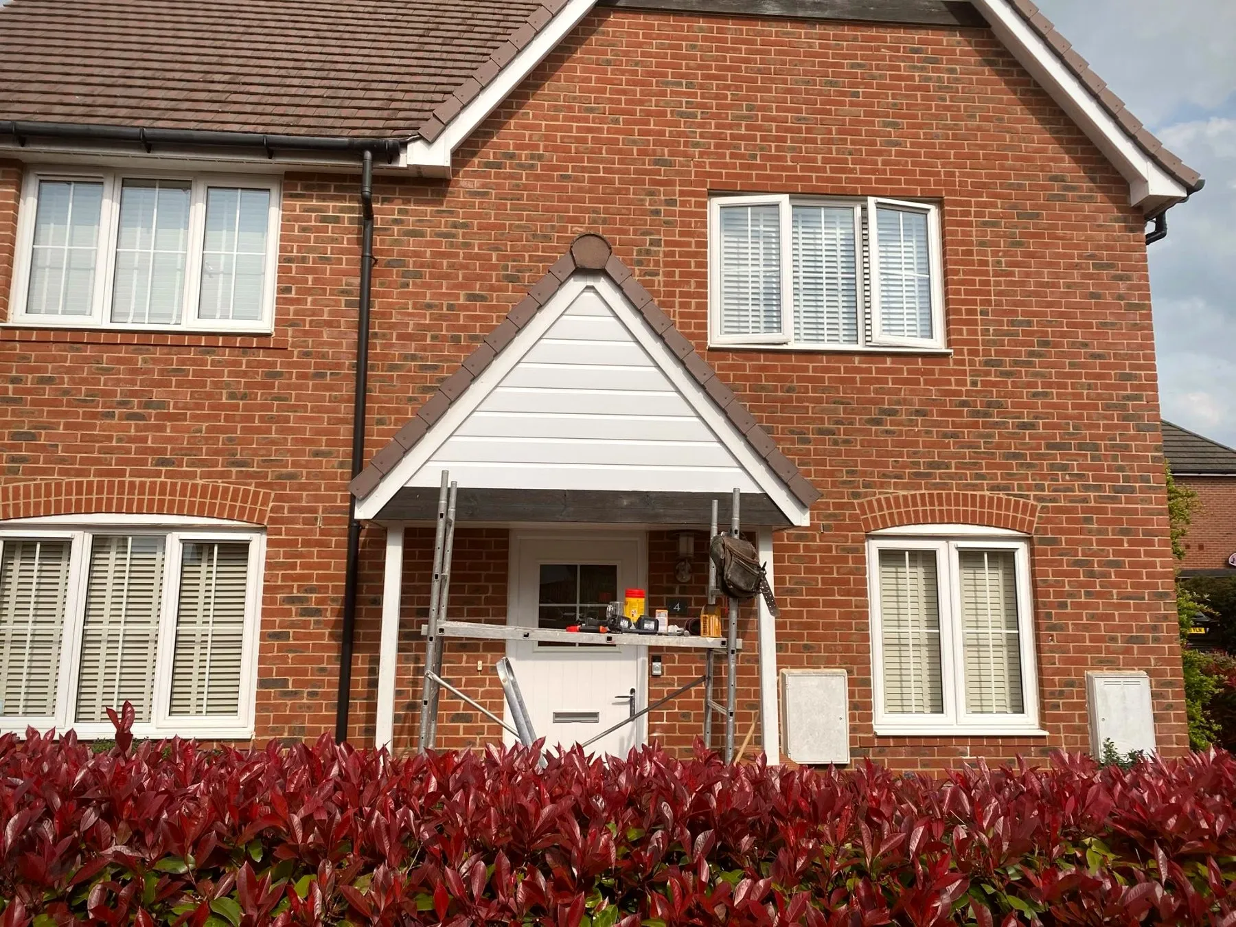 Rebuilt and painted porch, white with brown roof