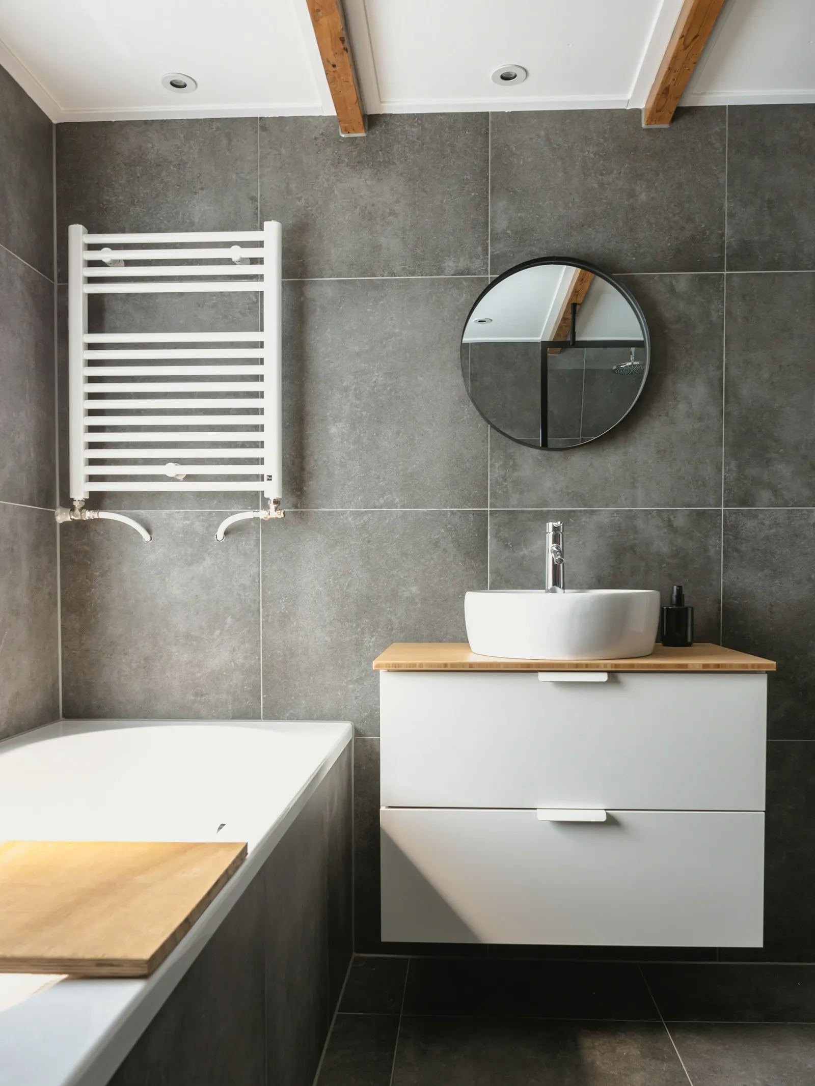 Modern grey-tiled family bathroom with floating vanity