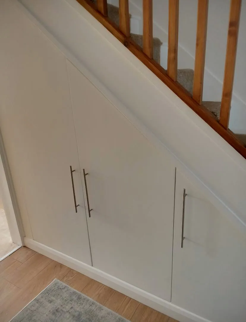 Fitted white shaker under-stairs storage